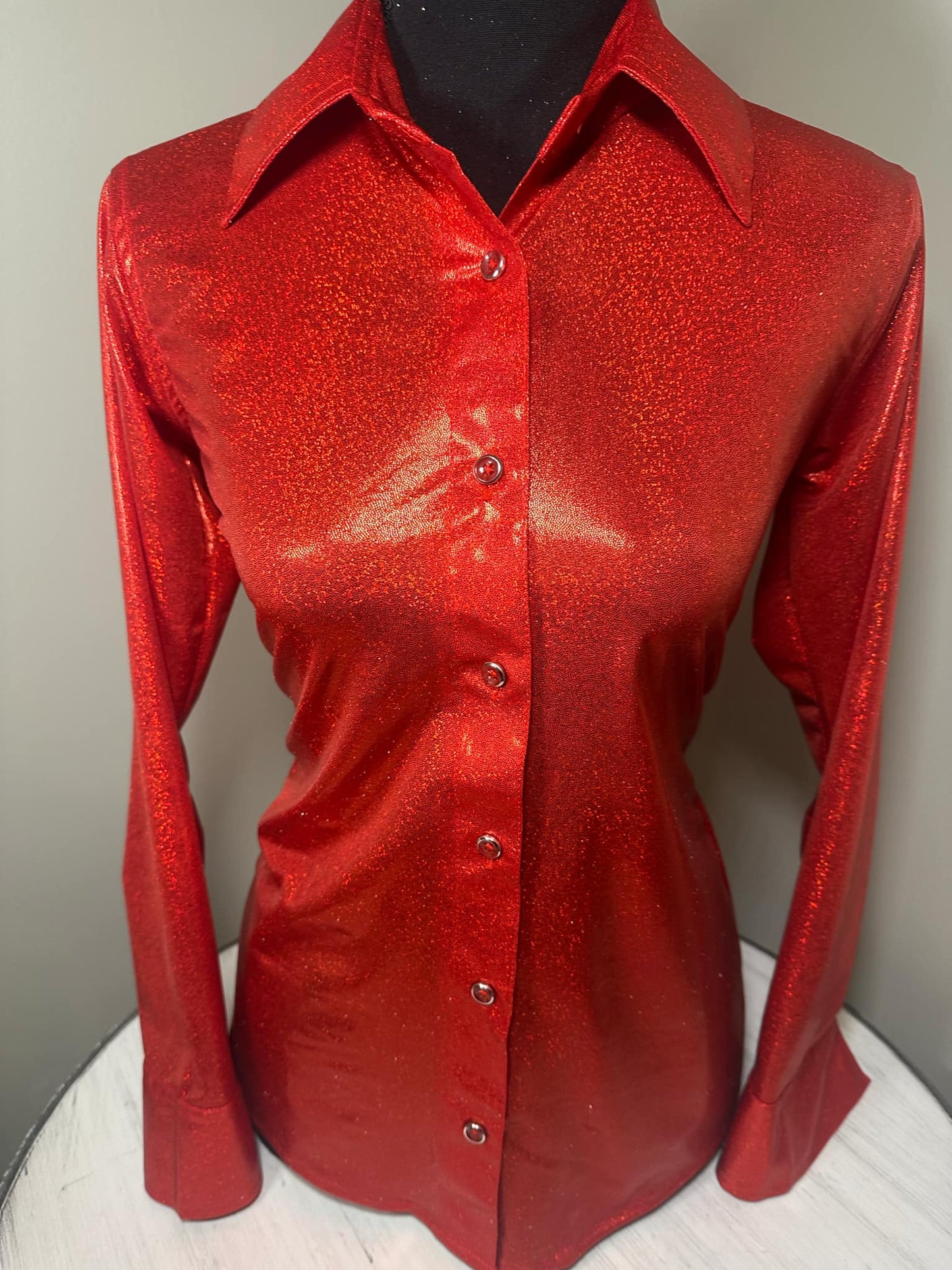 This vibrant red shirt, sprinkled with tiny sequins, exudes confidence and captures the spirit of the rodeo.