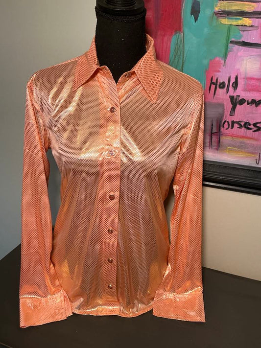 This image features a peach rodeo show shirt with button up detailing and a shiny textured fabric.